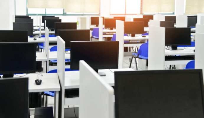 Row of computers at university computer classroom.